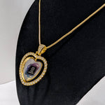 Customizable double-sided heart shaped gold rhinestone pendant with a gold necklace on a black stand