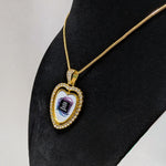 Customizable heart-shaped rhinestone gold pendant with a gold chain on a black stand