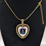 Customizable double-sided heart shaped gold rhinestone pendant with a gold necklace on a black stand