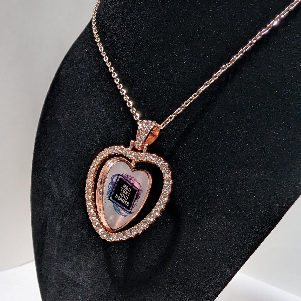 Customizable double-sided heart shaped rose gold rhinestone pendant with a rose gold necklace on a black stand