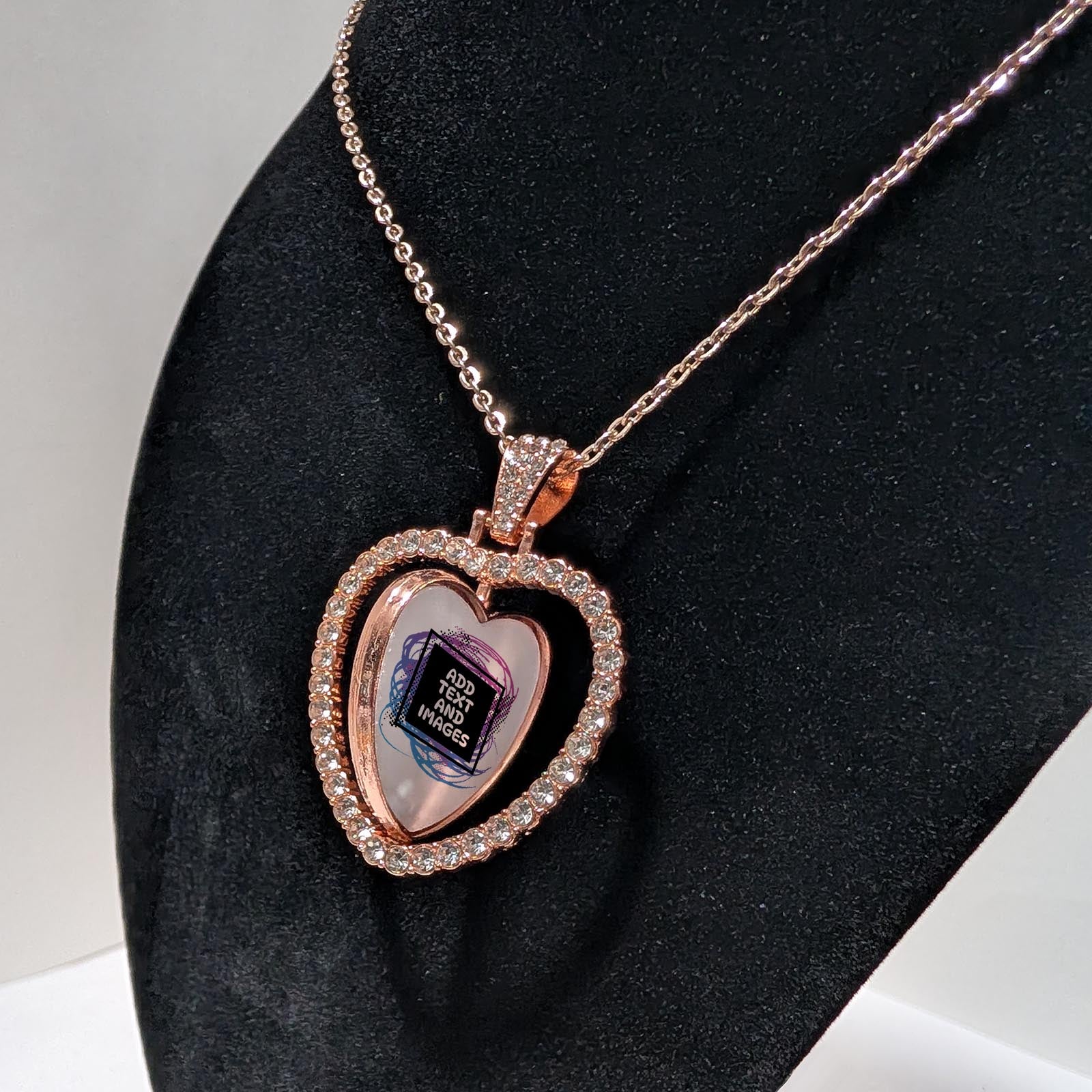 Customizable double-sided heart shaped rose gold rhinestone pendant with a rose gold necklace on a black stand