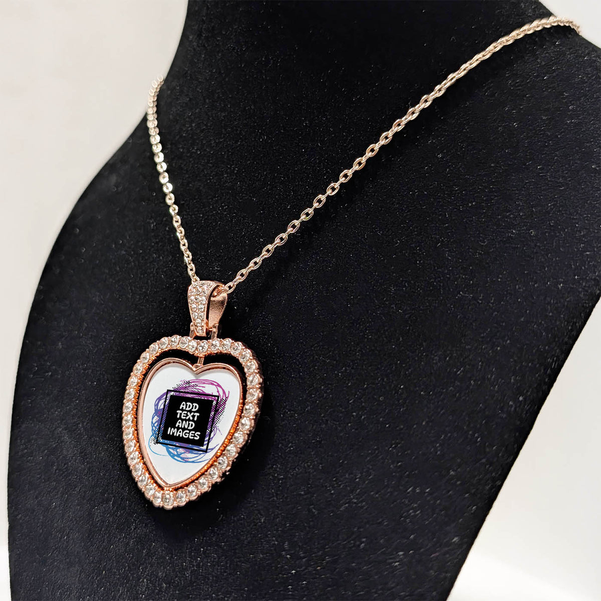 Customizable double-sided heart shaped rose gold rhinestone pendant with a rose gold necklace on a black stand