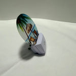 LED night light with a tropical design on a white surface