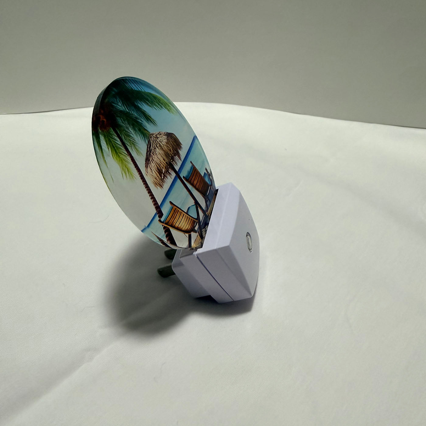 LED night light with a tropical design on a white surface