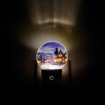 Decorative night light with a christmas town on a dark background